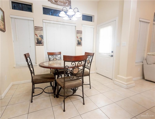 907 Amethyst Dr, Weslaco, TX 78596 - dining space with light tile patterned floors, a chandelier, and baseboards