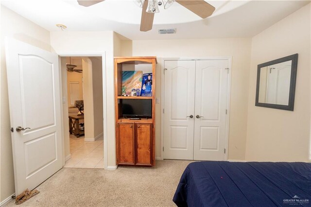 907 Amethyst Dr, Weslaco, TX 78596 - bedroom featuring a closet, light colored carpet, and ceiling fan