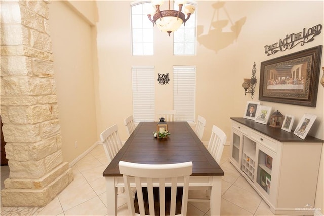907 Amethyst Dr, Weslaco, TX 78596 - dining room featuring light tile patterned floors, a chandelier, and a towering ceiling