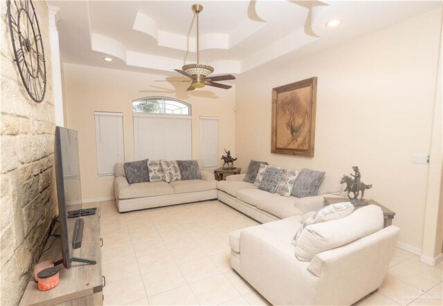 907 Amethyst Dr, Weslaco, TX 78596 - living room with ceiling fan, a tray ceiling, light tile patterned floors, recessed lighting, and baseboards
