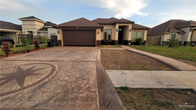 prairie-style home featuring a garage and a front lawn