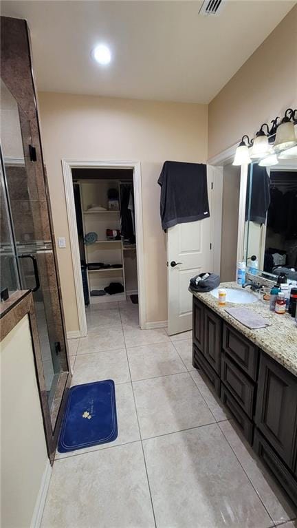 bathroom featuring vanity, tile patterned floors, and an enclosed shower