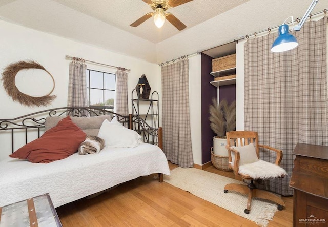 bedroom featuring ceiling fan and wood finished floors