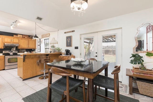 dining room with light tile patterned floors, visible vents, a chandelier, and french doors