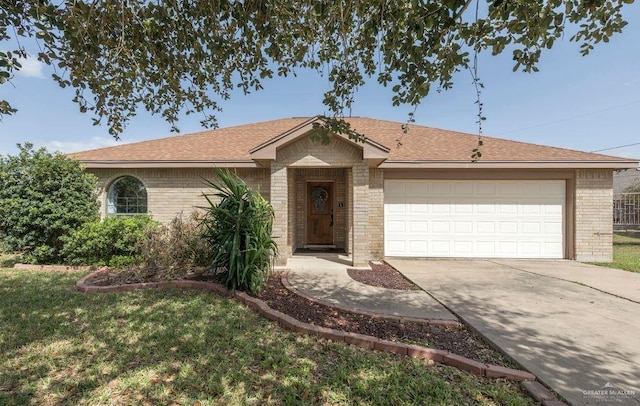 single story home with a garage, brick siding, driveway, and roof with shingles