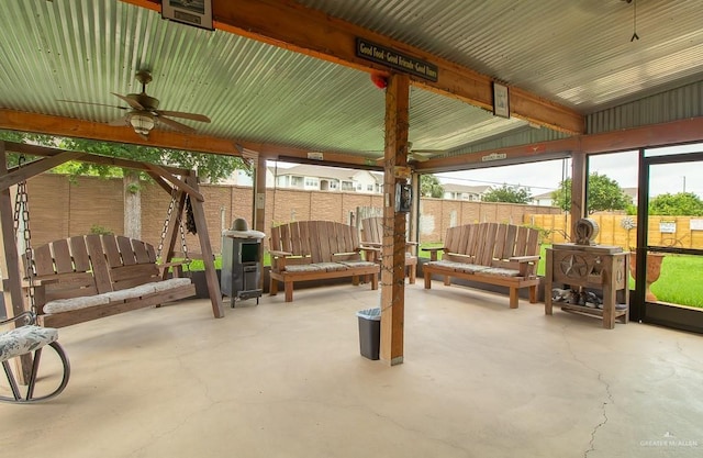 view of patio featuring a ceiling fan and fence