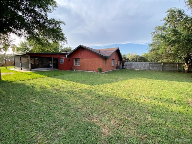 view of side of property with a sunroom and central AC