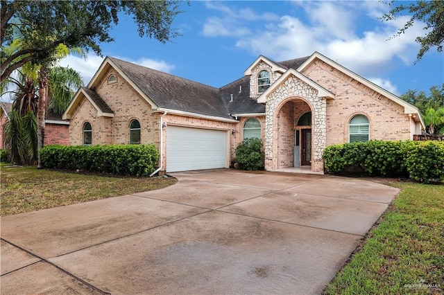 view of front facade with a garage and a front lawn