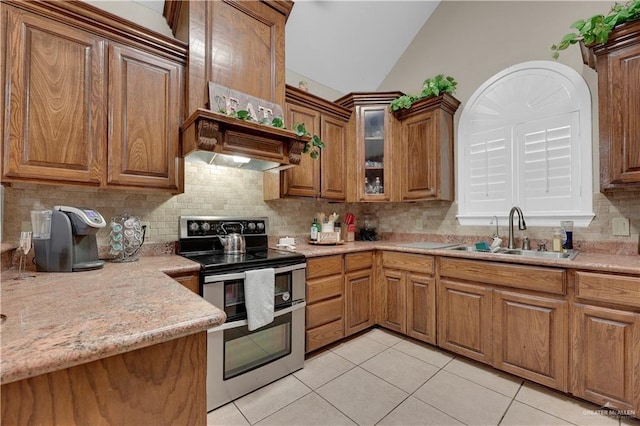 kitchen with tasteful backsplash, stainless steel range with electric stovetop, sink, light tile patterned floors, and lofted ceiling