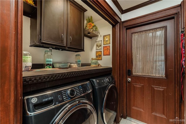 washroom with cabinets, washer and dryer, and ornamental molding