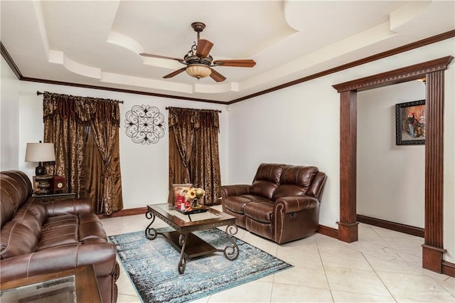 living room featuring a raised ceiling, ceiling fan, crown molding, and light tile patterned flooring