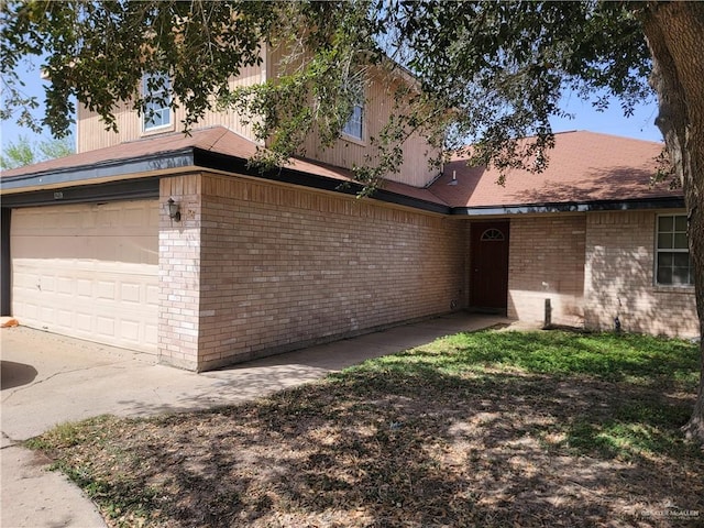 ranch-style house with a garage and brick siding