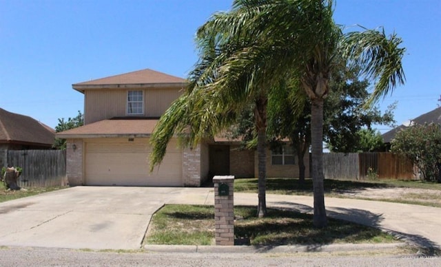 view of front of house with a garage, concrete driveway, brick siding, and fence