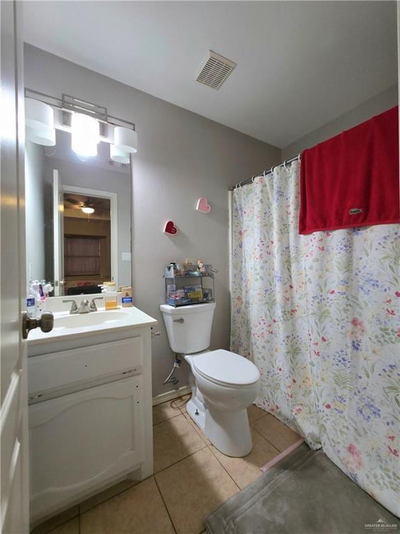 full bathroom featuring tile patterned floors, vanity, a shower with curtain, toilet, and visible vents