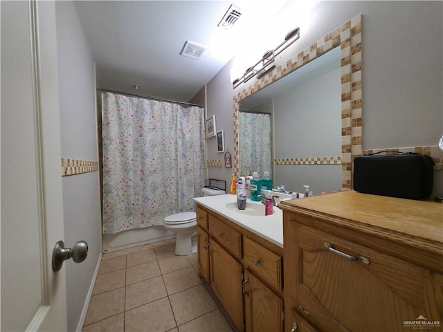 bathroom featuring toilet, vanity, tile patterned floors, and visible vents