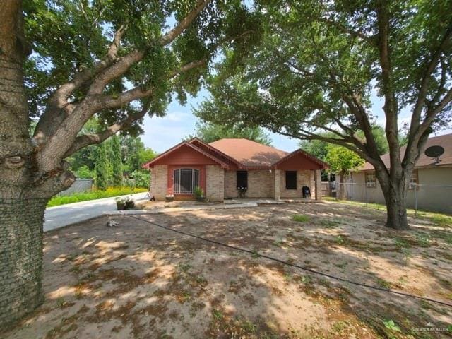 ranch-style home with fence