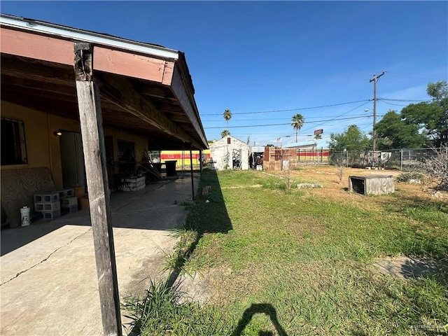 203 N Kansas Ave, Weslaco, TX 78596 - view of yard featuring a carport and concrete driveway