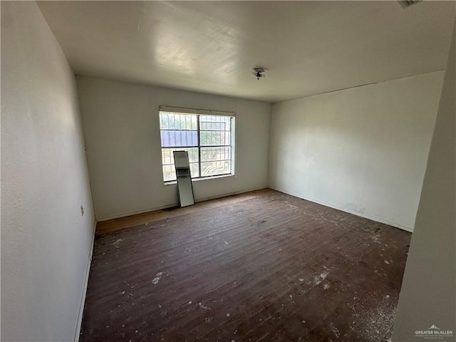 empty room with dark hardwood / wood-style floors