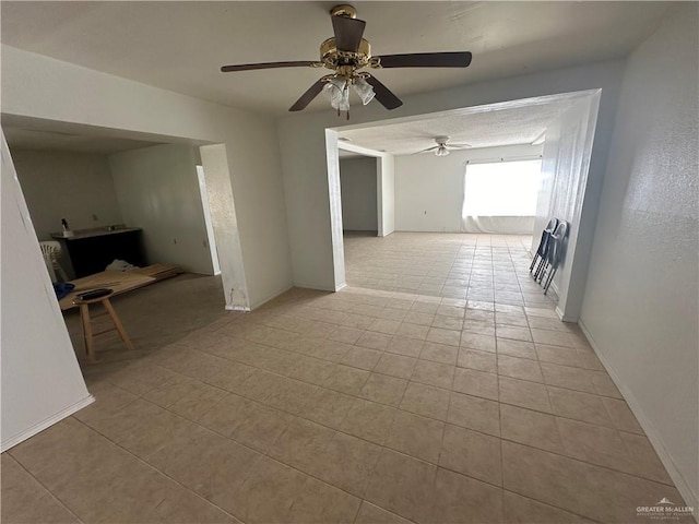 spare room with light tile patterned floors and ceiling fan