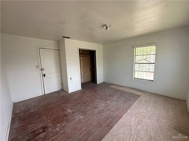 unfurnished bedroom with hardwood / wood-style floors