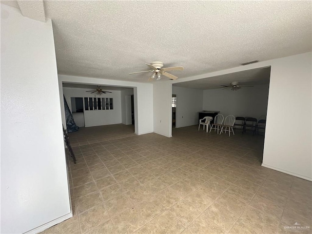 spare room featuring ceiling fan and a textured ceiling