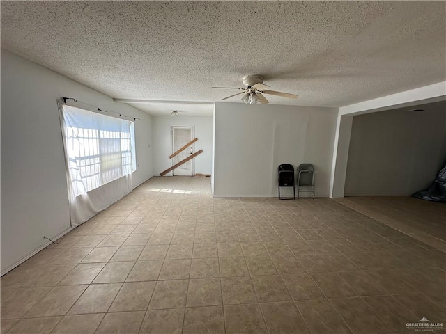 interior space with a textured ceiling and ceiling fan