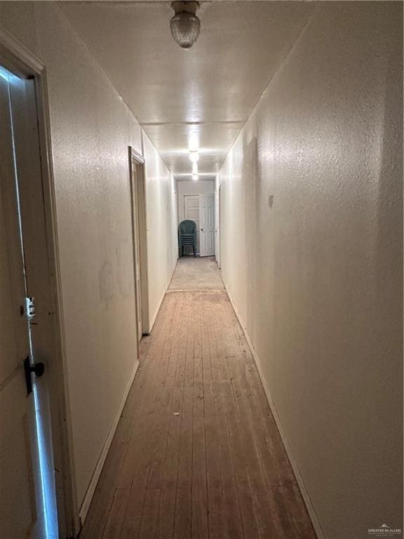 203 N Kansas Ave, Weslaco, TX 78596 - corridor featuring wood-type flooring and baseboards