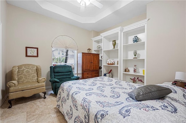 bedroom featuring a raised ceiling and ceiling fan