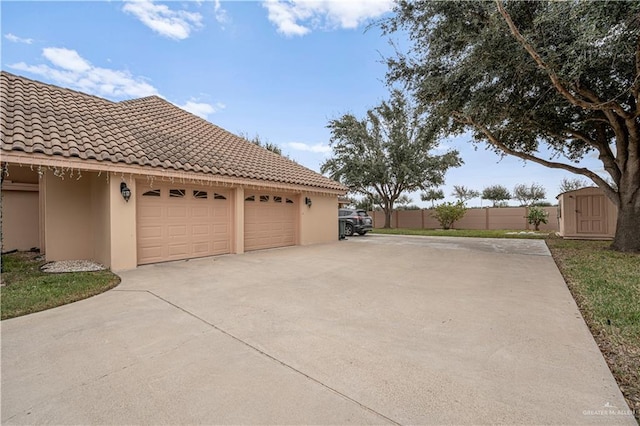 view of home's exterior featuring a garage and a storage shed