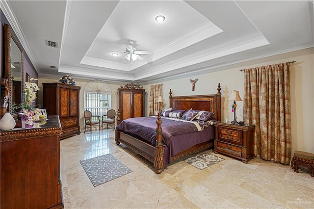 bedroom featuring a tray ceiling, ceiling fan, and ornamental molding