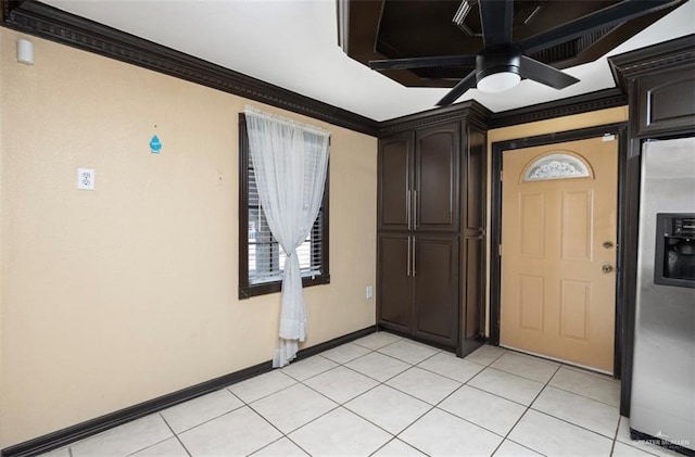 tiled foyer entrance featuring ceiling fan and crown molding