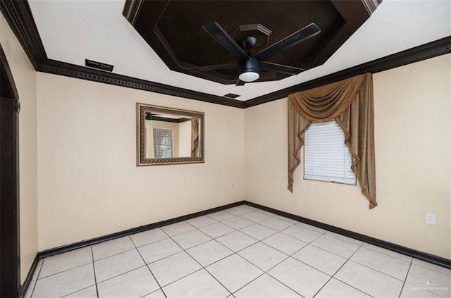 spare room with ceiling fan, ornamental molding, and light tile patterned floors