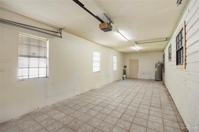 garage featuring electric water heater and a garage door opener