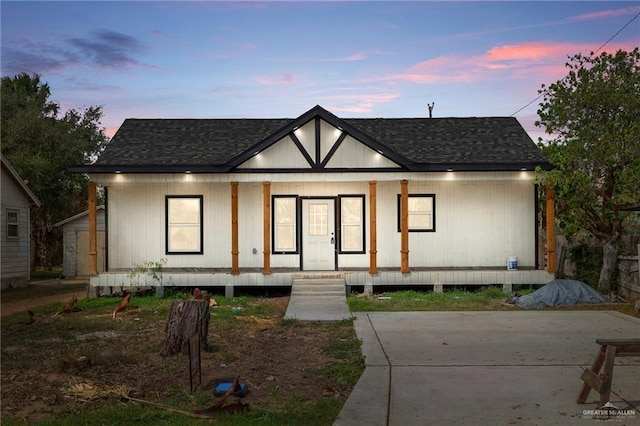 view of front of house featuring covered porch and roof with shingles