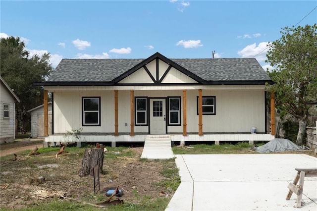 view of front facade with a porch and a shingled roof