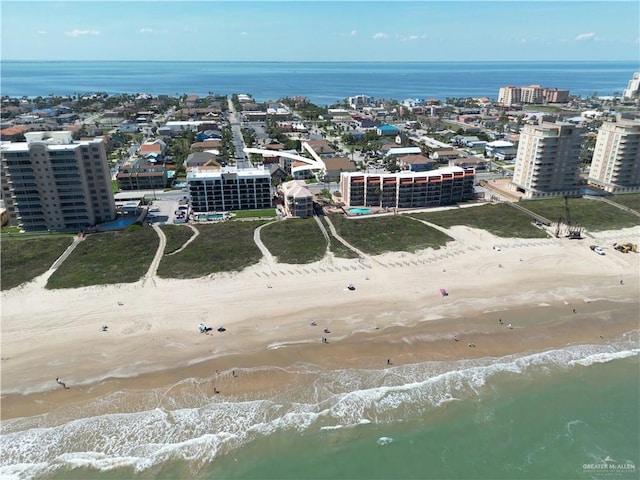 drone / aerial view featuring a view of the beach, a view of city, and a water view