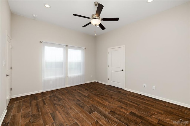 empty room with dark hardwood / wood-style floors and ceiling fan