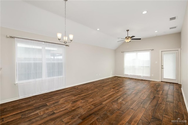 unfurnished living room featuring dark wood-type flooring, ceiling fan with notable chandelier, and vaulted ceiling