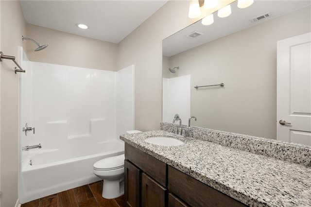 full bathroom featuring hardwood / wood-style flooring, vanity, shower / bath combination, and toilet