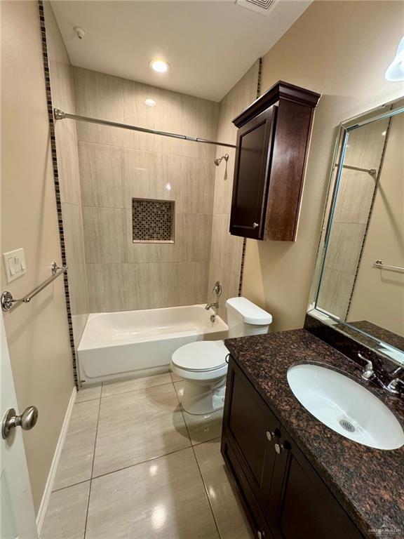 2611 E Eisenhower Ave, Mission, TX 78573 - bathroom with shower / tub combination, vanity, toilet, visible vents, and tile patterned flooring