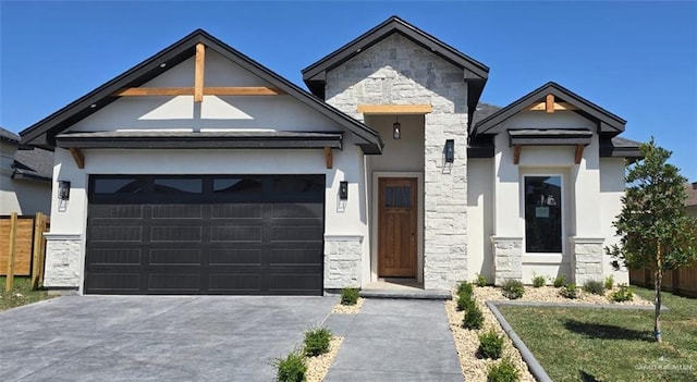 view of front of property with concrete driveway, a garage, stone siding, and stucco siding