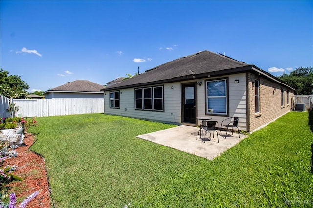 back of house featuring a yard, central AC, and a patio area