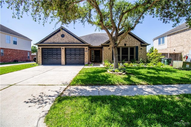 view of front of property featuring a garage and a front lawn