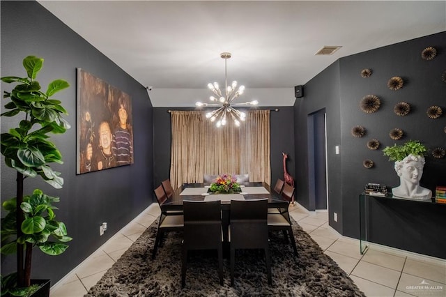 dining room with a chandelier and light tile patterned floors