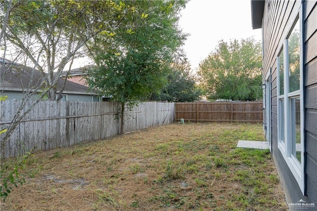 view of yard with a fenced backyard
