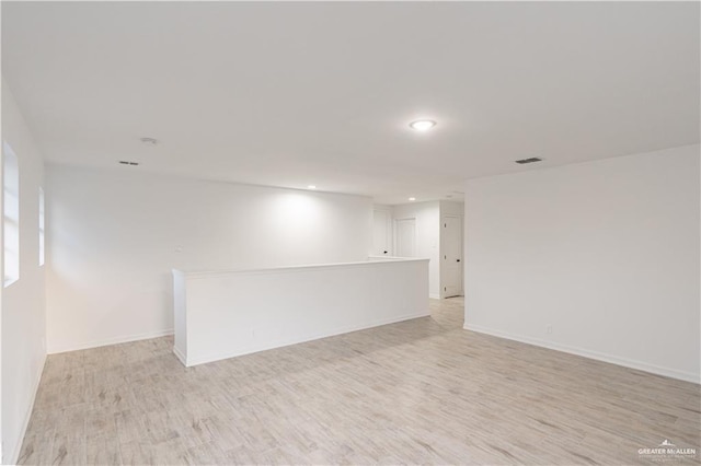 spare room with visible vents, baseboards, light wood finished floors, and recessed lighting