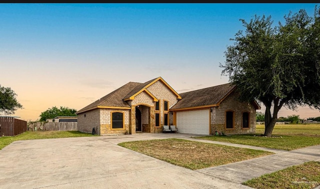 view of front of home featuring a garage and a lawn