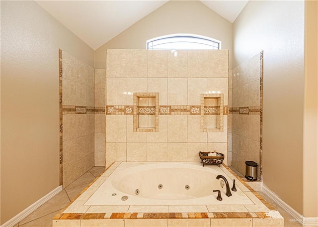 bathroom featuring lofted ceiling and tiled tub