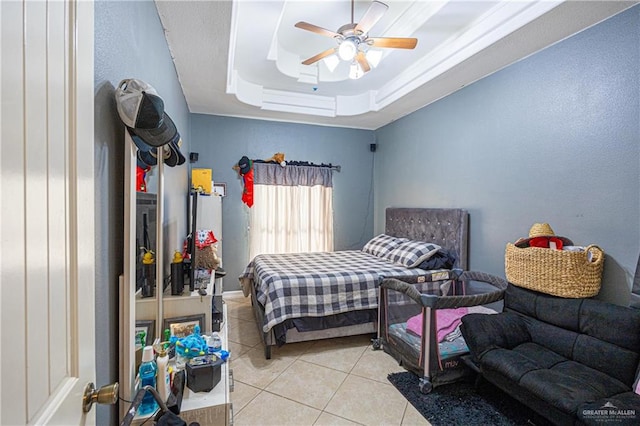 bedroom featuring a raised ceiling, ceiling fan, and light tile patterned flooring