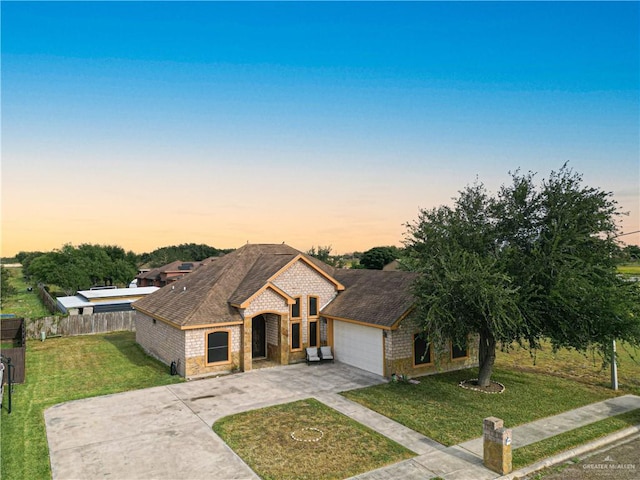 view of front facade with a lawn and a garage